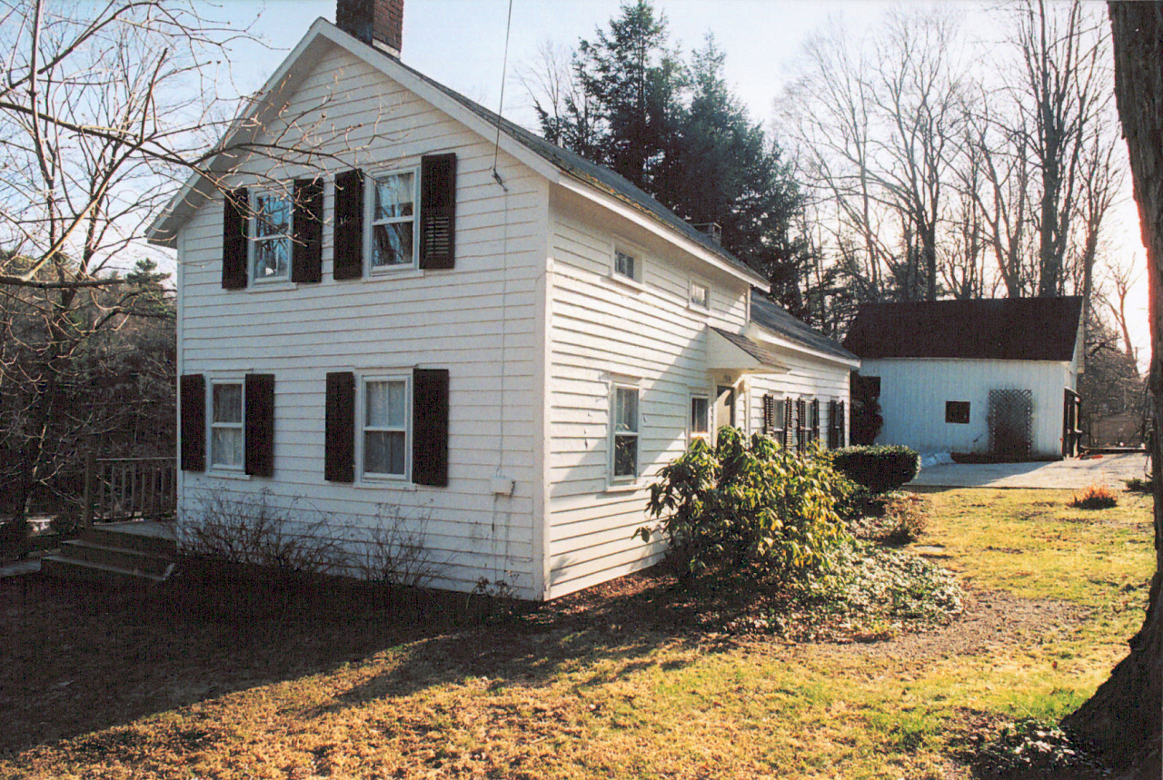 a view of a house with a yard covered in snow