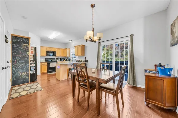 a dining room with furniture and wooden floor