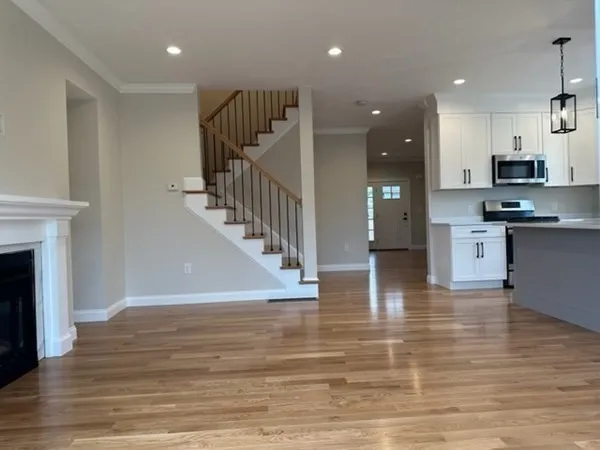a view of kitchen and hall with wooden floor