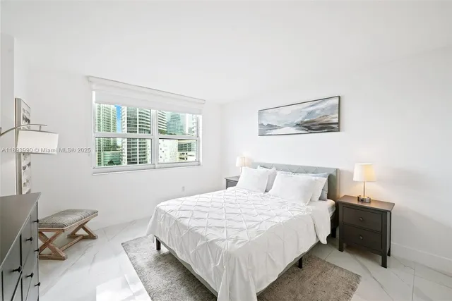 a bedroom with a bed and a lamp