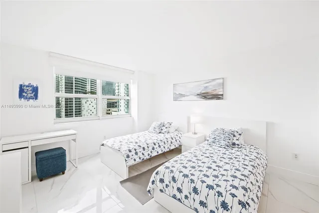 a bathroom with a shower sink mirror and toilet