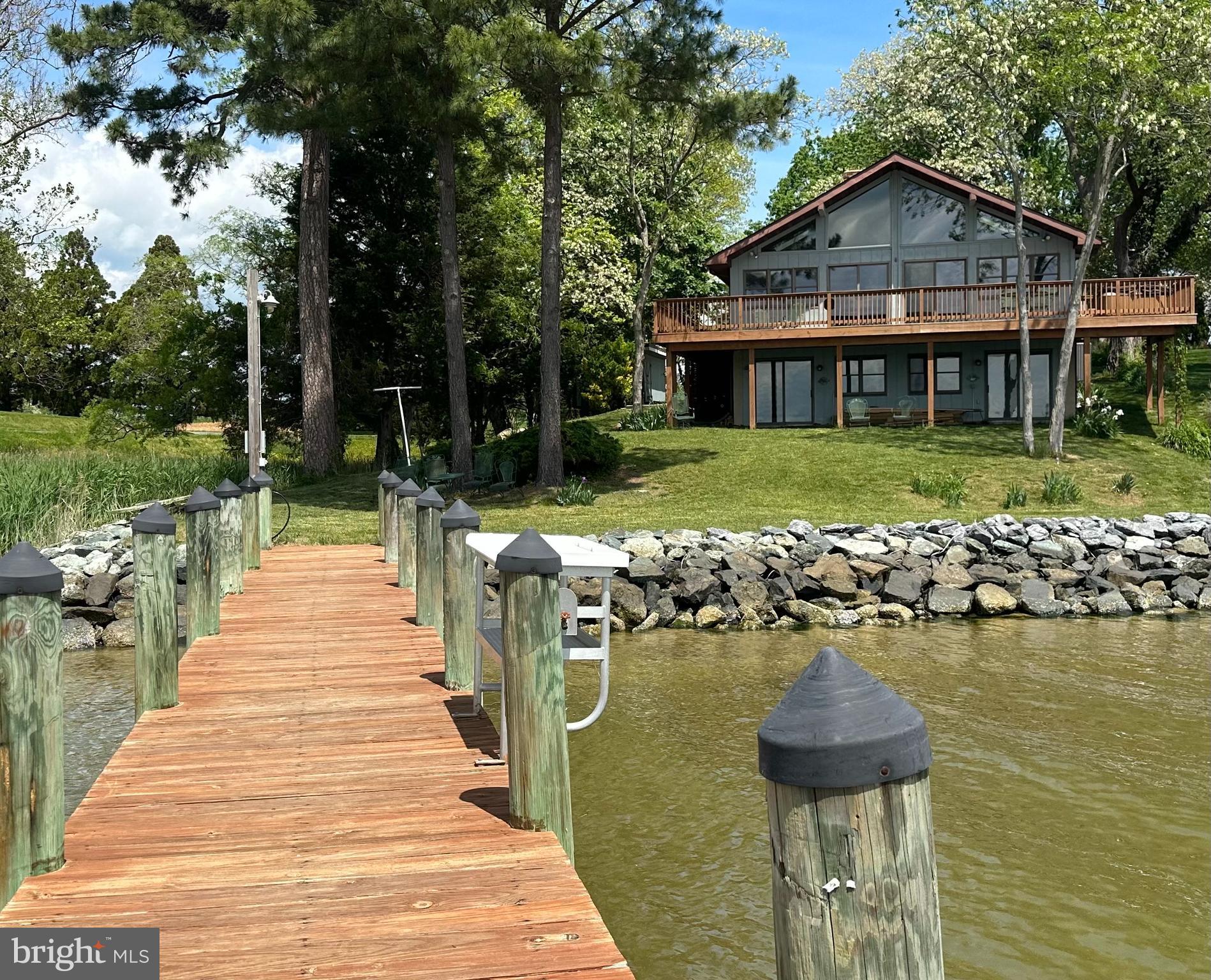 4836 Briscoe Road St. Leonard, MD 20685 - Photo 2 of 2 a front view of a house with swimming pool and garden