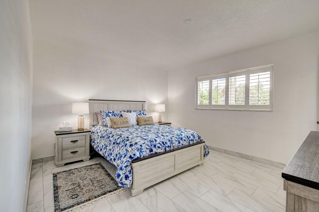 a bathroom with a toilet a sink a vanity and mirror