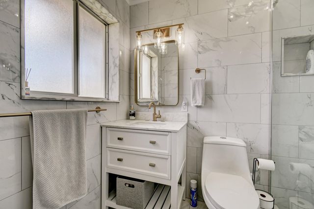 a bathroom with a shower toilet and sink