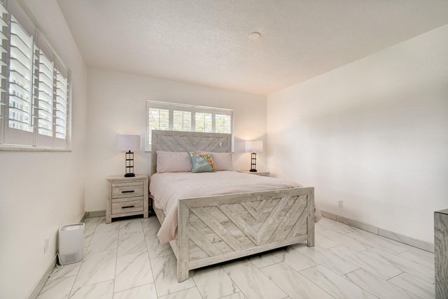 a bathroom with a toilet a sink a vanity and mirror