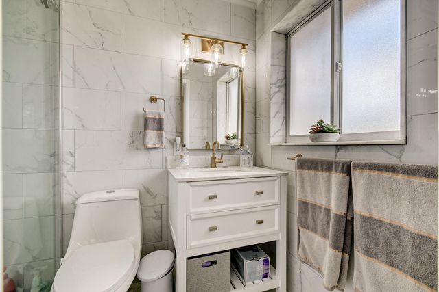 a bathroom with a sink toilet and shower