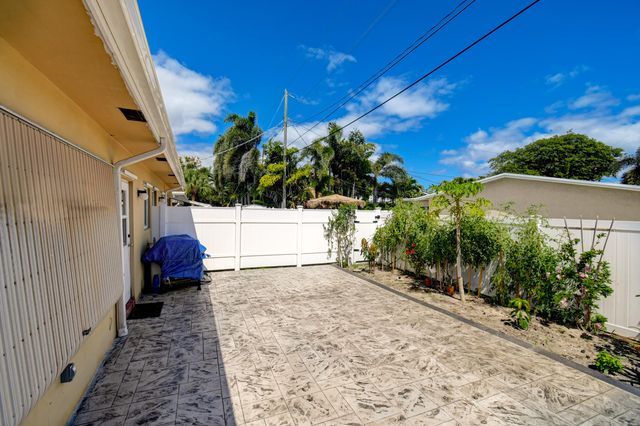 a front view of a house with yard and green space