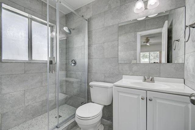 a kitchen with granite countertop a stove top oven microwave and cabinets