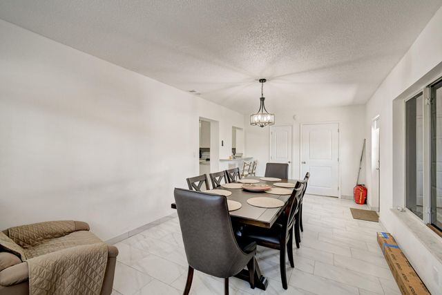 a kitchen with stainless steel appliances kitchen island granite countertop a stove sink and cabinets