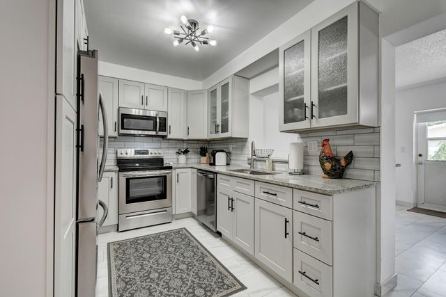 a kitchen with a refrigerator stove and sink