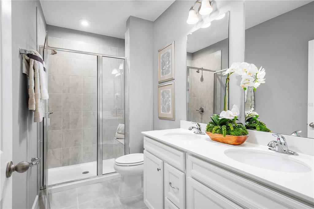 1186 Turtle Is Road Fruitland Park, FL 34731 - Photo 10 of 11 a bathroom with a granite countertop shower sink vanity mirror and toilet