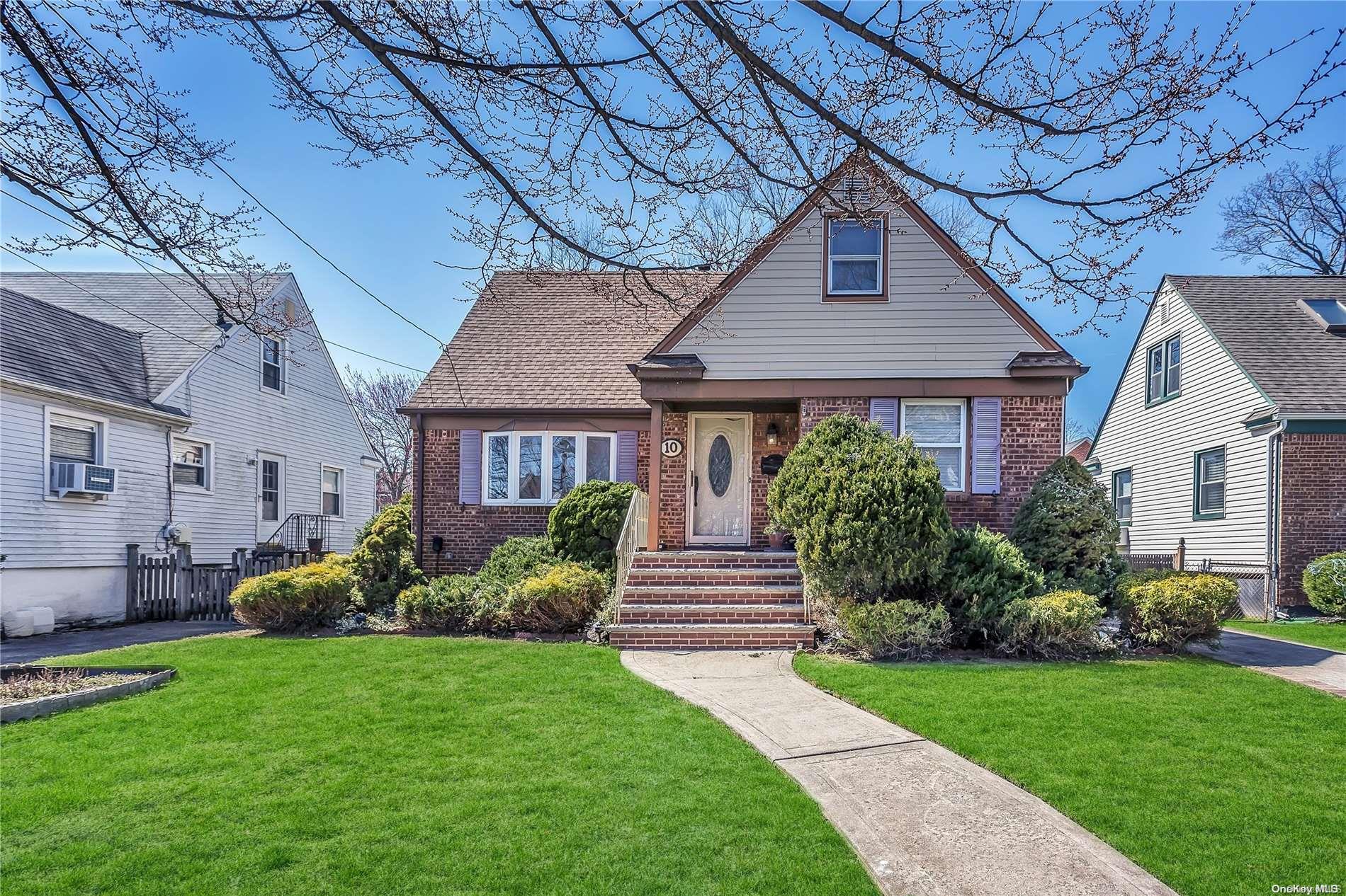 10 Babylon Road Merrick, NY 11566 - Photo 1 of 1 a front view of a house with garden