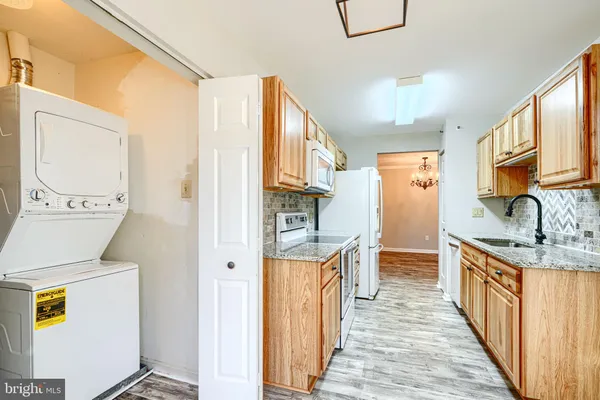 a hallway with a sink a washer and dryer