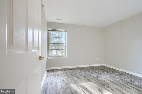 a view of wooden floor and windows in a room