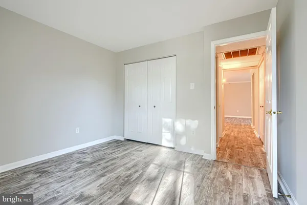 a view of empty room with wooden floor