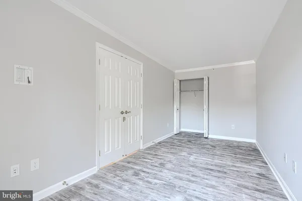 a view of an empty room with wooden floor