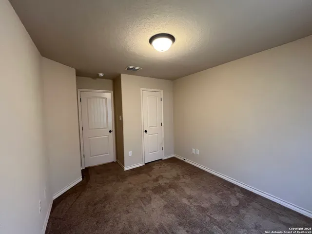 an empty room with a empty space and windows