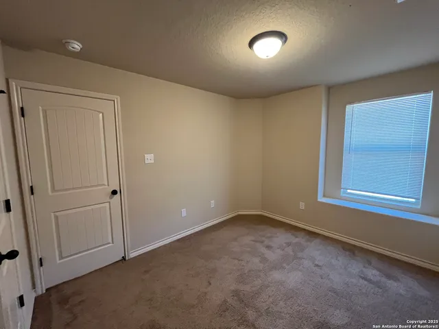 a view of an empty room and a window