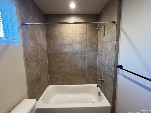 a bathroom with a white bath tub