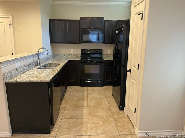 a kitchen with a sink and a refrigerator