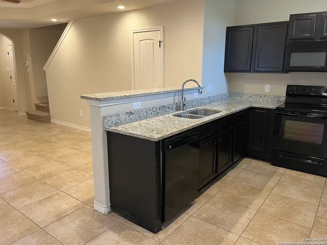 a kitchen with a sink and a stove
