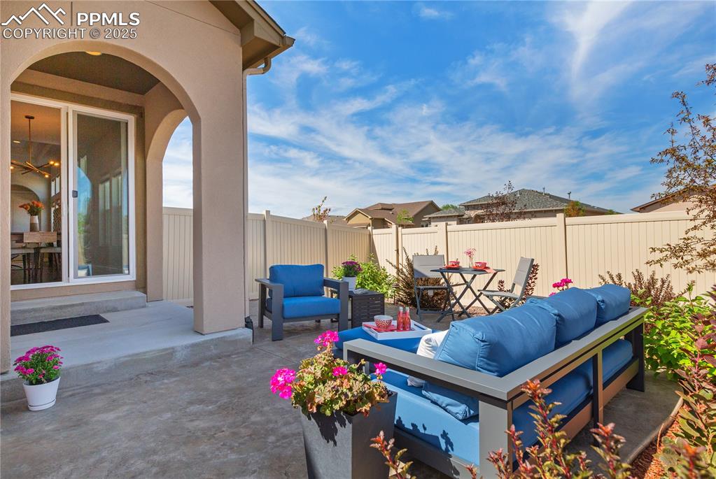 12516 Stone Valley Drive Peyton, CO 80831 - Photo 16 of 44 a view of a patio with table and chairs potted plants