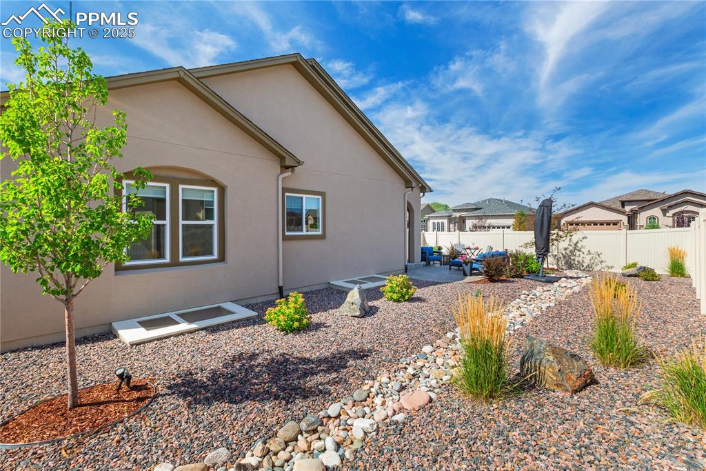 12516 Stone Valley Drive Peyton, CO 80831 - Photo 18 of 44 a front view of a house with garden