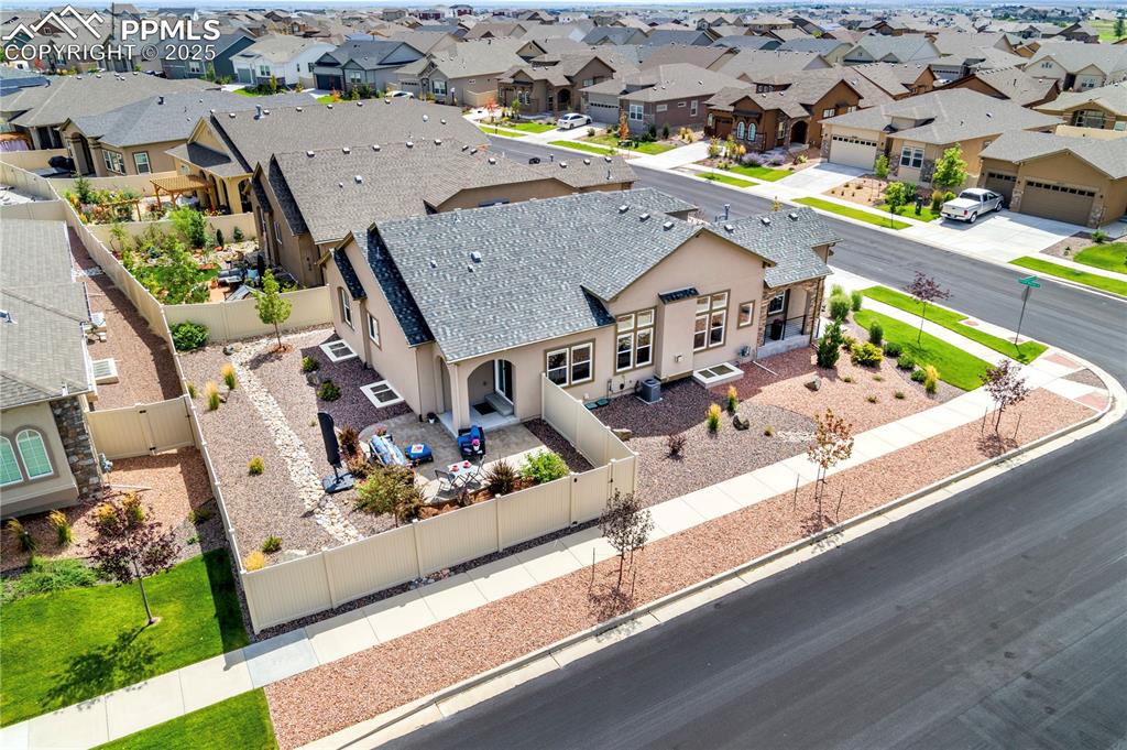 12516 Stone Valley Drive Peyton, CO 80831 - Photo 19 of 44 an aerial view of a house with a garden and mountain view in back