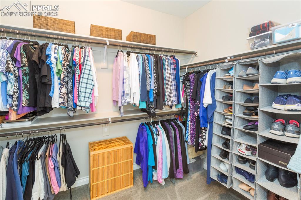 12516 Stone Valley Drive Peyton, CO 80831 - Photo 24 of 44 a view of walk in closet with clothes and shoes