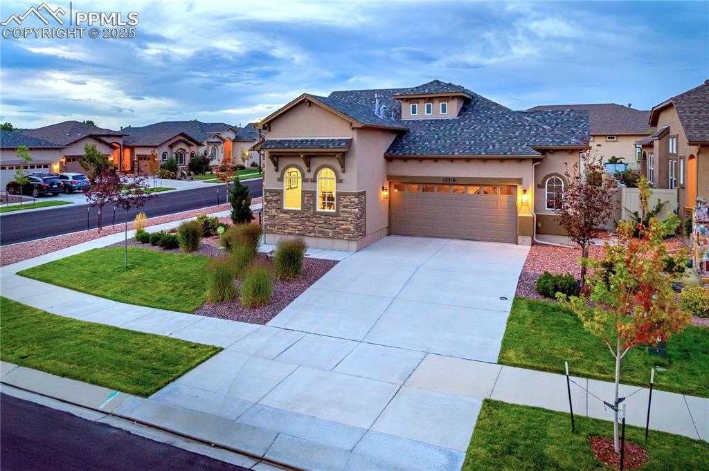 12516 Stone Valley Drive Peyton, CO 80831 - Photo 3 of 44 a front view of a house with a yard