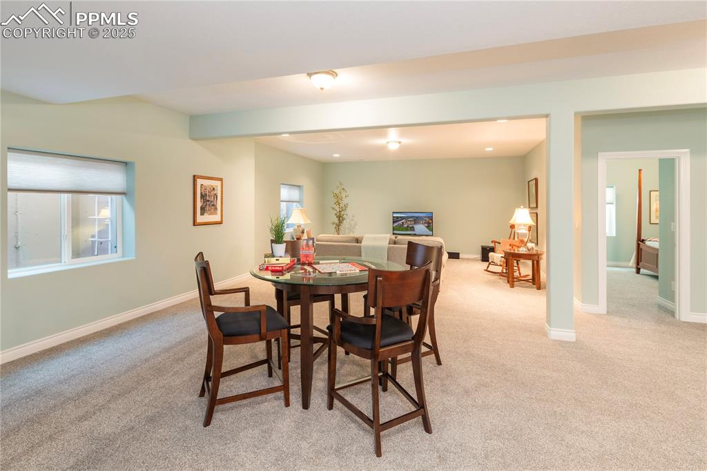 12516 Stone Valley Drive Peyton, CO 80831 - Photo 32 of 44 a view of a dining room with furniture and a livingroom