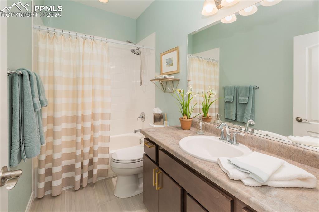 12516 Stone Valley Drive Peyton, CO 80831 - Photo 36 of 44 a bathroom with a granite countertop sink toilet and shower