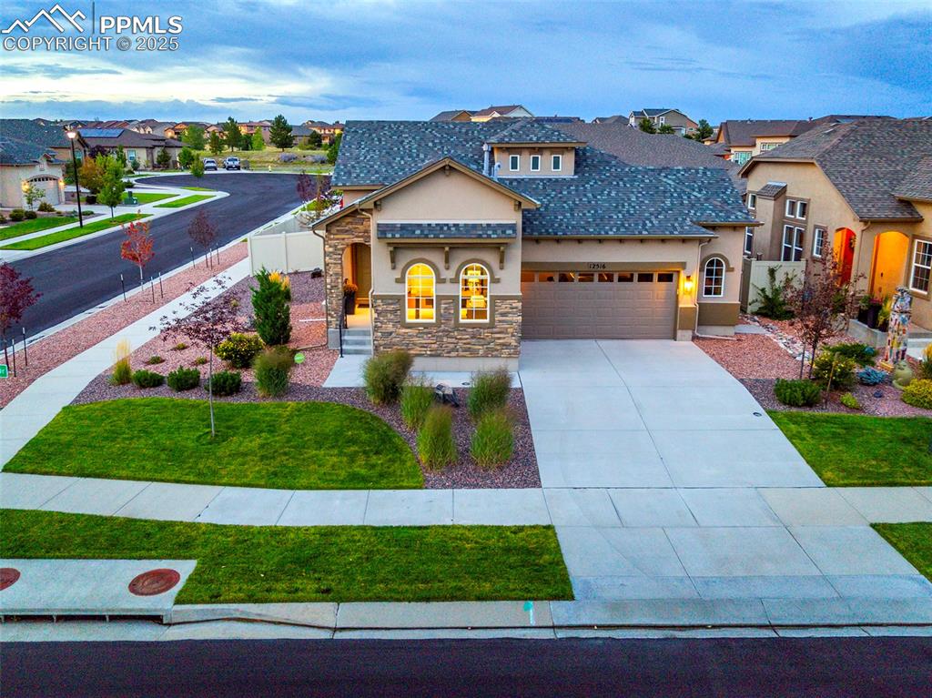 12516 Stone Valley Drive Peyton, CO 80831 - Photo 37 of 44 a front view of a house with garden
