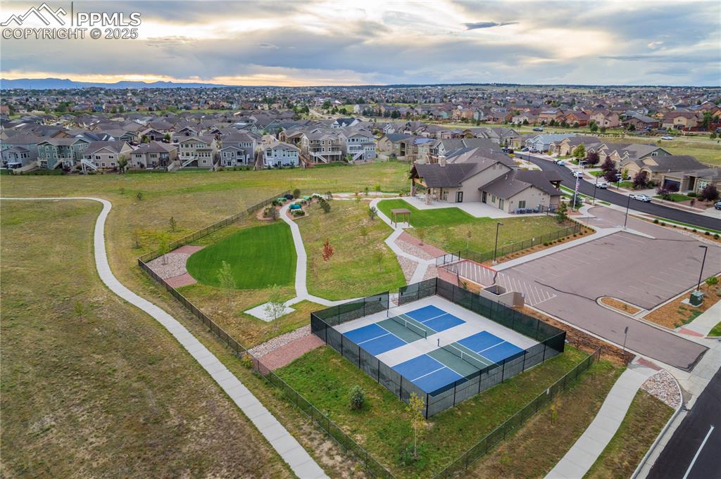 12516 Stone Valley Drive Peyton, CO 80831 - Photo 41 of 44 an aerial view of a house with a swimming pool lake and mountain view in back