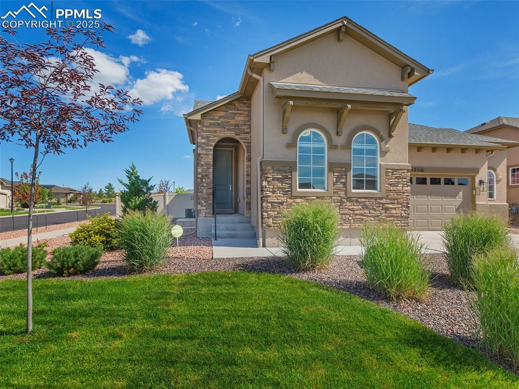 12516 Stone Valley Drive Peyton, CO 80831 - Photo 6 of 44 a front view of a house with garden