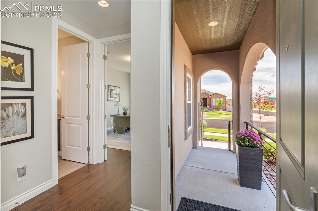 12516 Stone Valley Drive Peyton, CO 80831 - Photo 8 of 44 a view of a hallway with wooden floor and a dining room