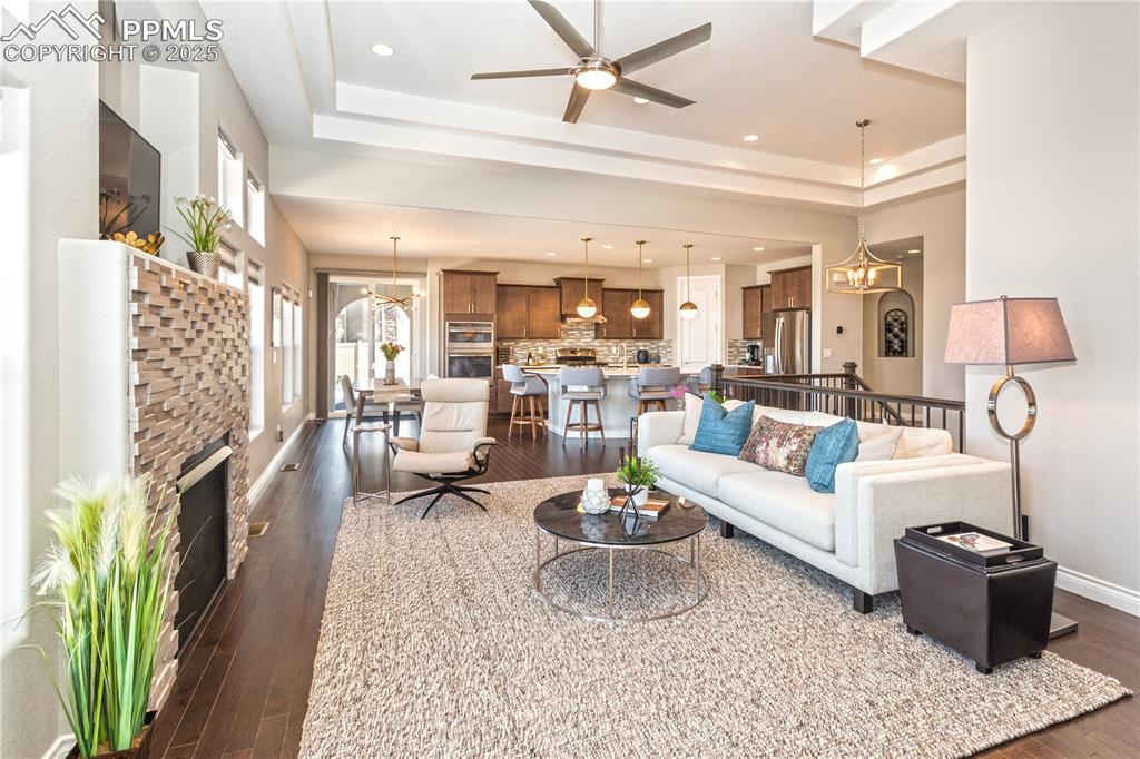 12516 Stone Valley Drive Peyton, CO 80831 - Photo 9 of 44 a living room with fireplace furniture and a rug