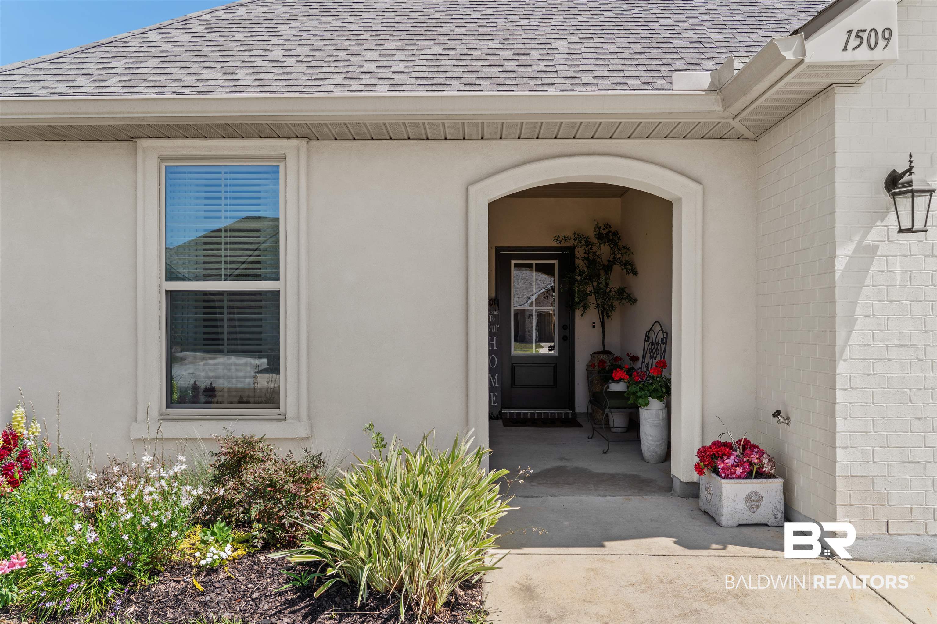 1509 Fenton Circle Foley, AL 36535 - Photo 5 of 34 Doorway to property featuring brick siding, a shingled roof, and stucco siding