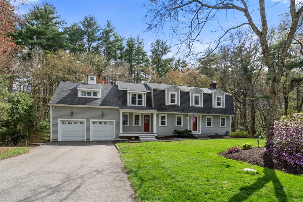 27 Middle Road Sudbury, MA 01776 - Photo 1 of 33 a front view of a house with a garden and trees