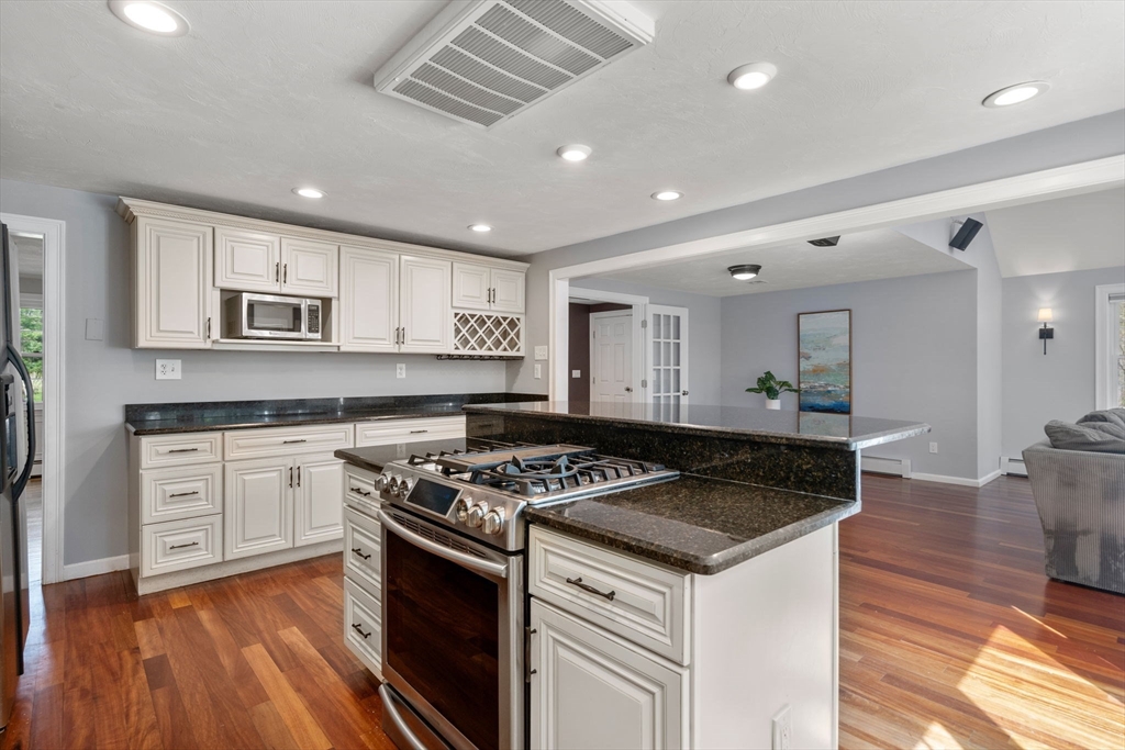 27 Middle Road Sudbury, MA 01776 - Photo 11 of 33 a kitchen with granite countertop stainless steel appliances a stove sink and cabinets