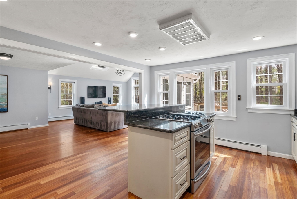 27 Middle Road Sudbury, MA 01776 - Photo 12 of 33 a kitchen with stainless steel appliances granite countertop wooden cabinets and a stove top oven