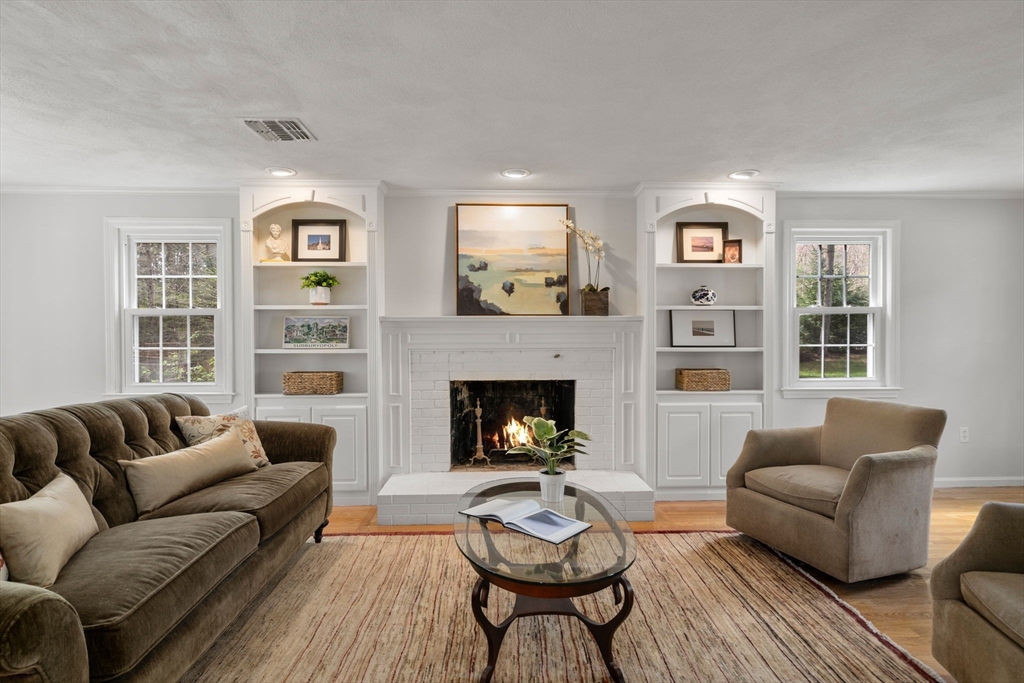 27 Middle Road Sudbury, MA 01776 - Photo 14 of 33 a living room with furniture and a fireplace