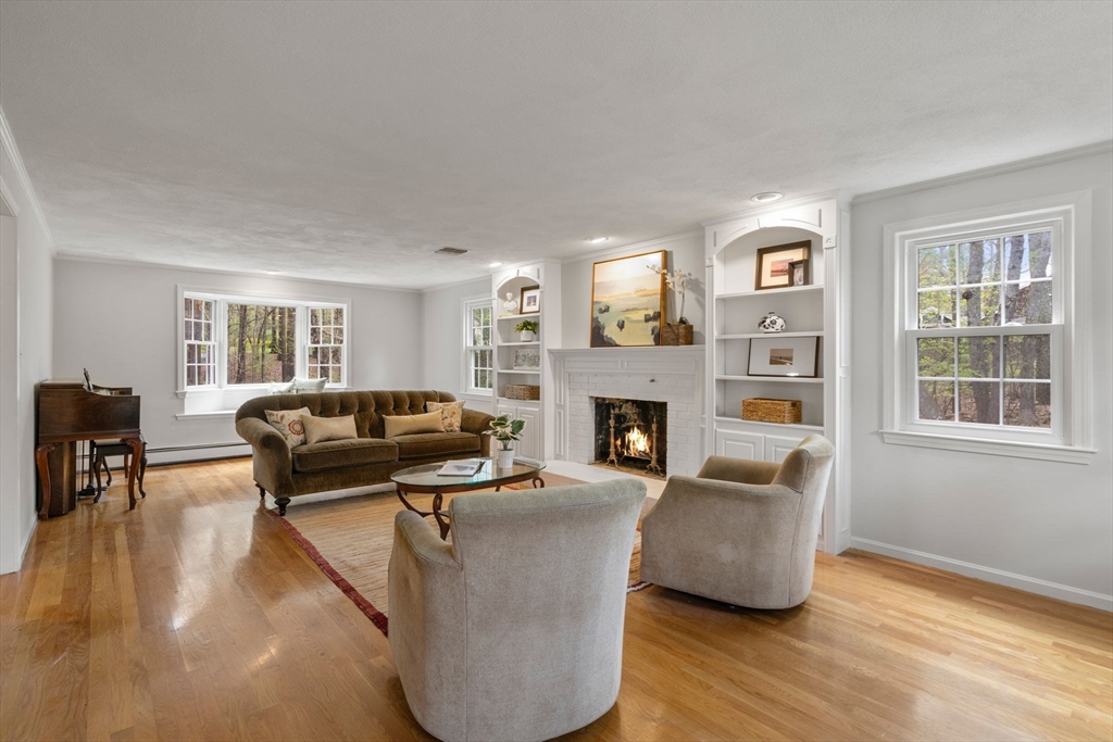 27 Middle Road Sudbury, MA 01776 - Photo 15 of 33 a living room with furniture a fireplace and a window