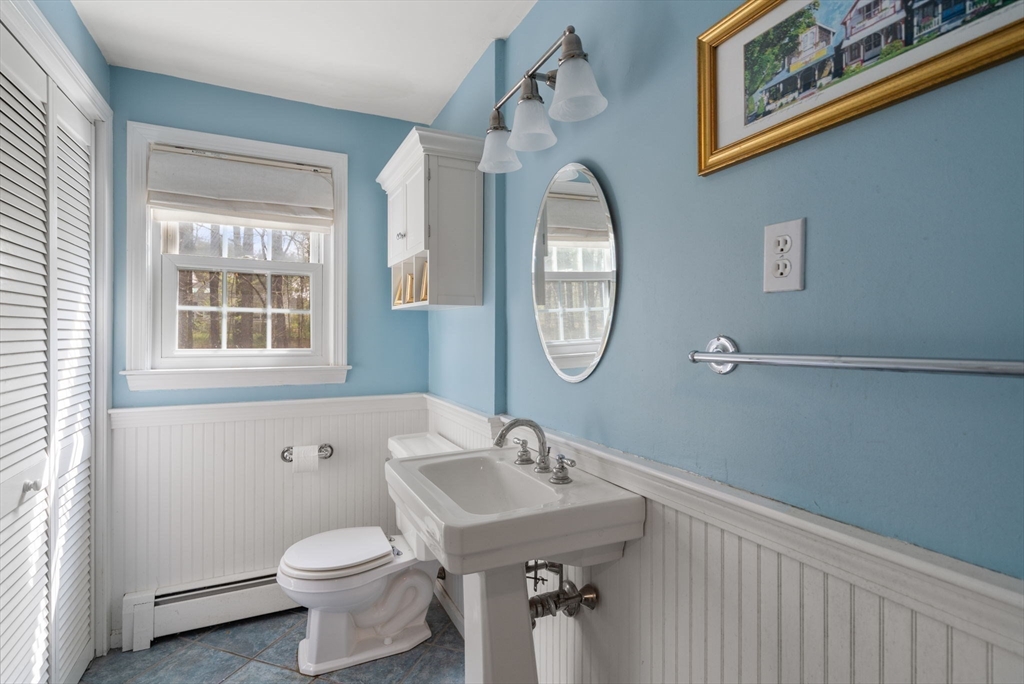 27 Middle Road Sudbury, MA 01776 - Photo 17 of 33 a bathroom with a toilet a sink a mirror and a window