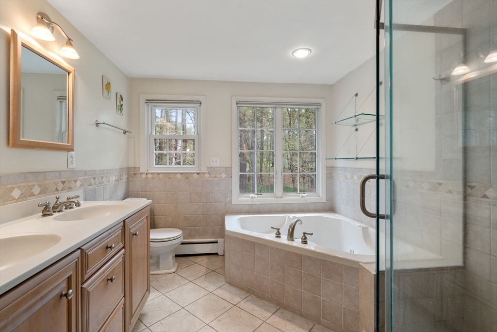 27 Middle Road Sudbury, MA 01776 - Photo 21 of 33 a bathroom with a bathtub sink a toilet and a window
