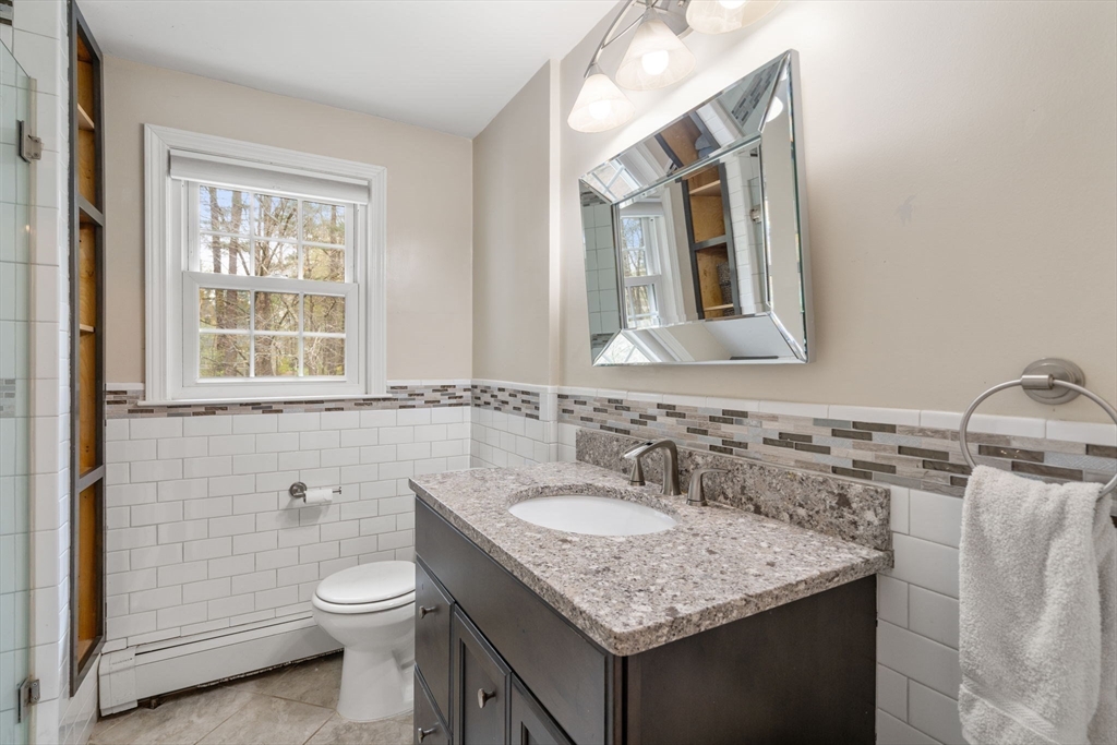 27 Middle Road Sudbury, MA 01776 - Photo 26 of 33 a bathroom with a granite countertop toilet sink and mirror