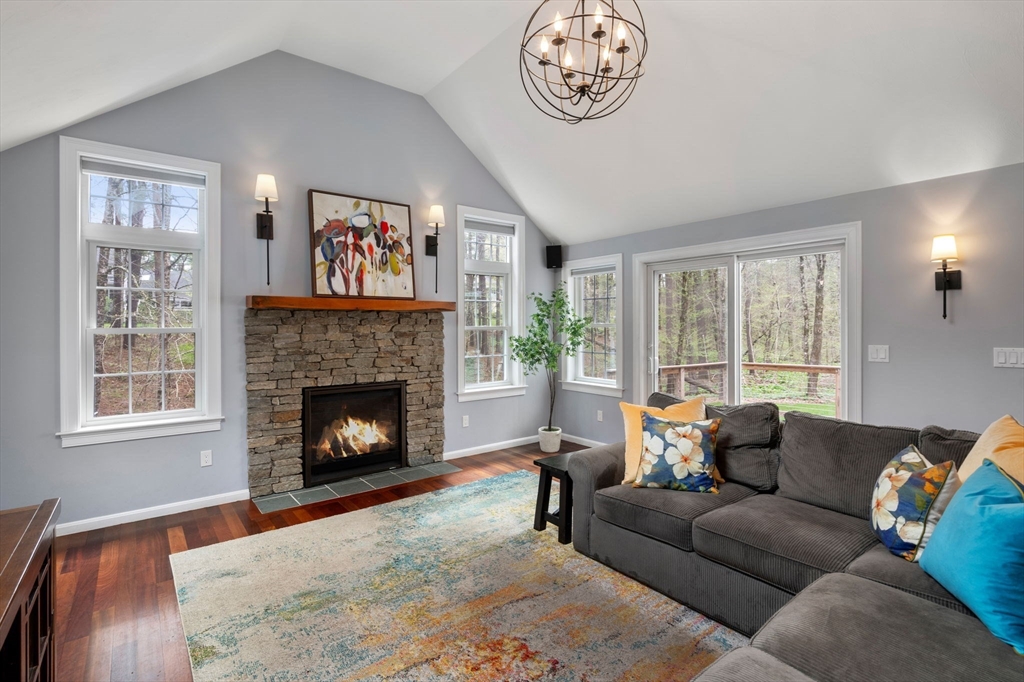 27 Middle Road Sudbury, MA 01776 - Photo 7 of 33 a living room with furniture a fireplace and a large window