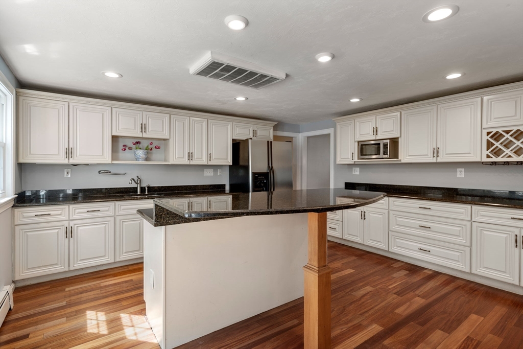 27 Middle Road Sudbury, MA 01776 - Photo 10 of 33 a large kitchen with stainless steel appliances granite countertop a stove a sink and a refrigerator