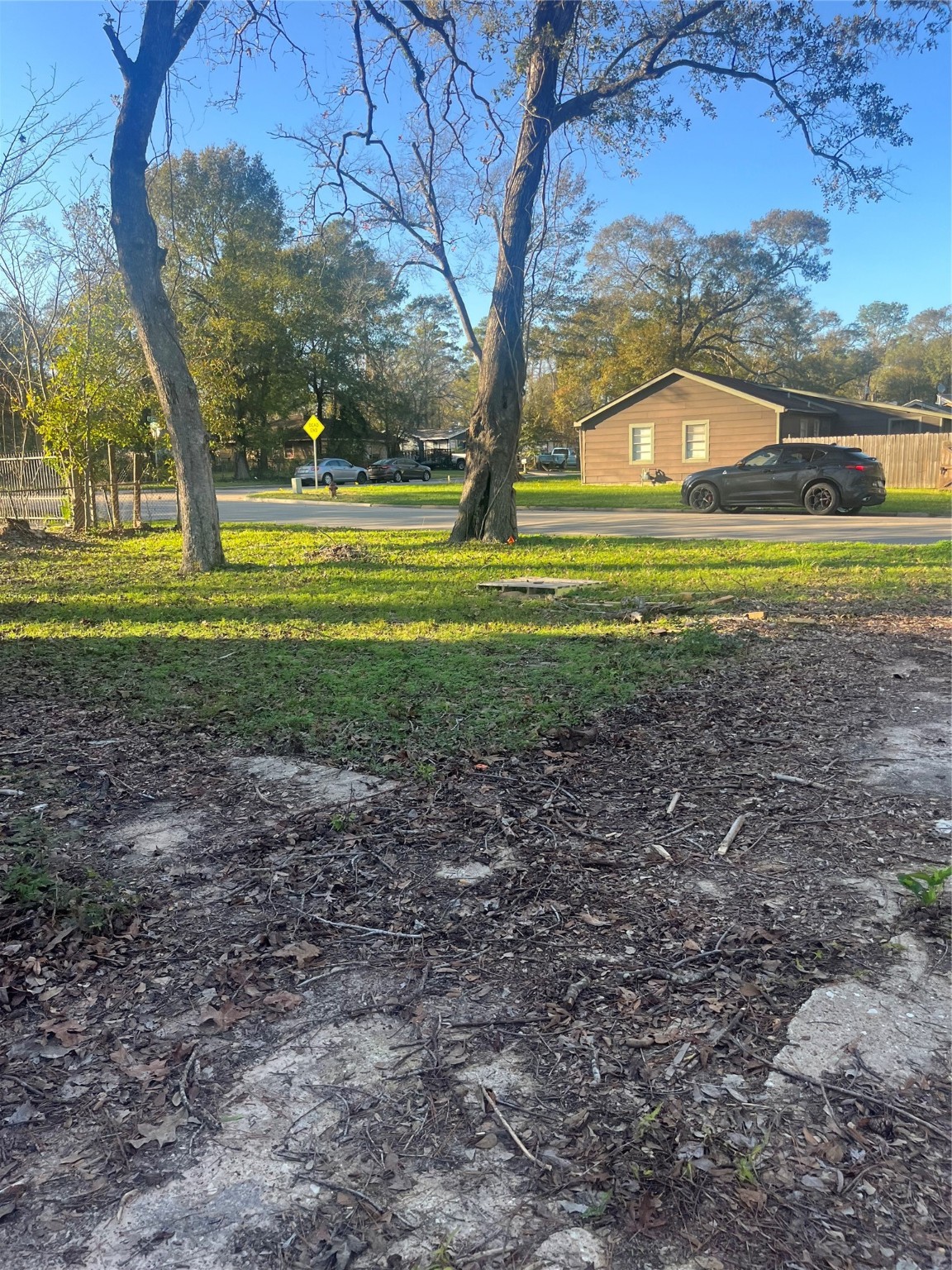 409 Wagers Street Conroe, TX 77301 - Photo 15 of 21 a view of a house with a big yard and large trees