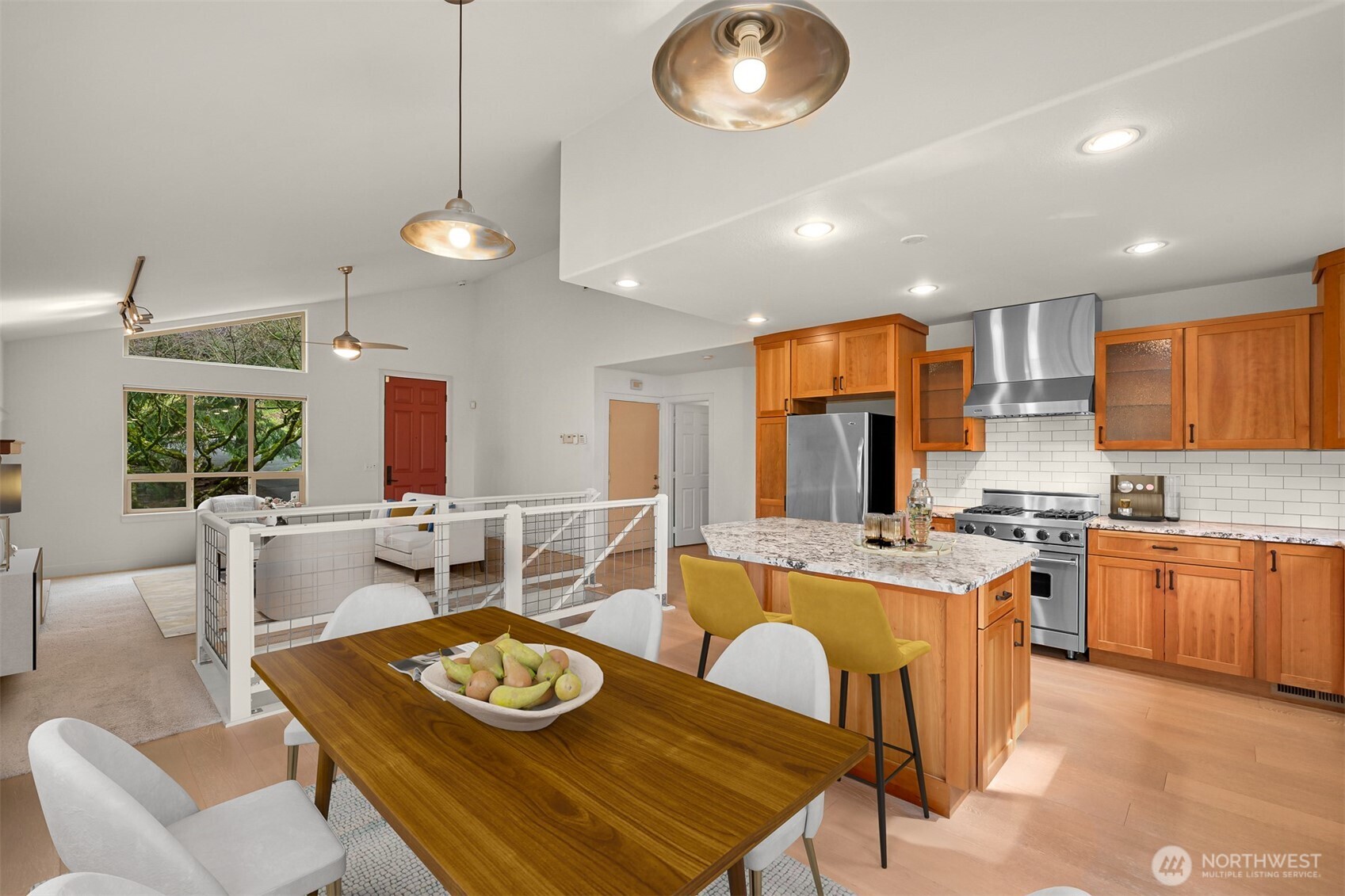 4135 Agate Road Bellingham, WA 98226 - Photo 6 of 36 a kitchen with stainless steel appliances granite countertop a stove a sink a dining table and chairs with wooden floor